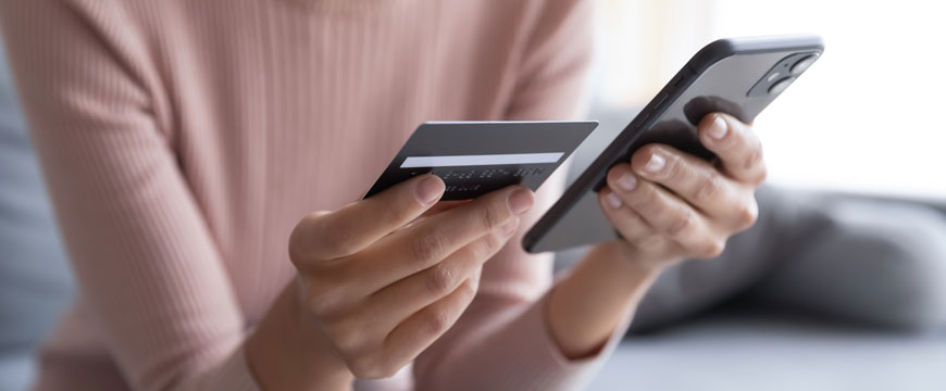 Girl Holding Phone and Credit Card
