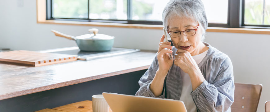 Lady on the Phone While Looking at a Computer Screen