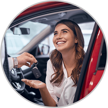 Woman receiving keys to new car