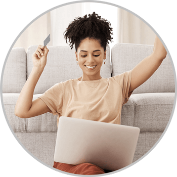 Woman holding debit card and celebrating