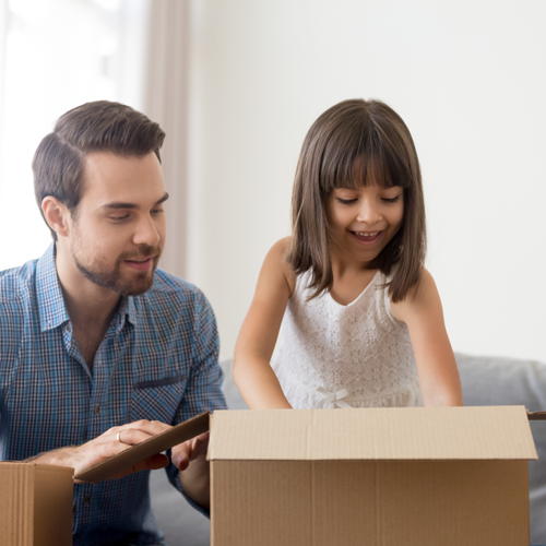 Little Girl Opening Box with Dad
