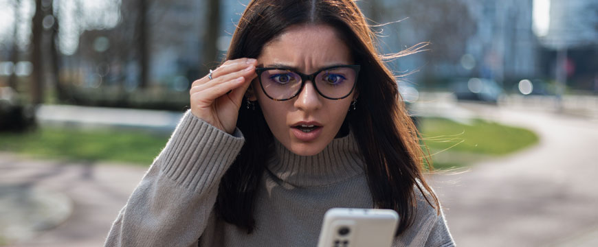 Girl Looking at a Phone in Confusion