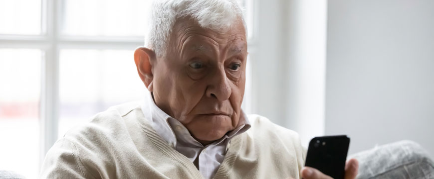 Man Looking at his Phone, In Shock