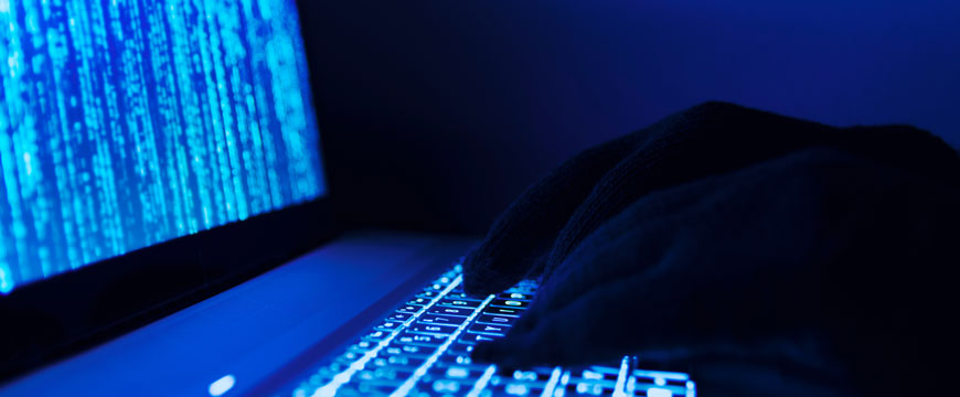 Cybercriminal Working on Computer