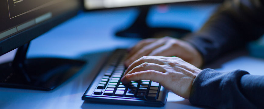 Cybercriminals Hands on a Computer Keyboard