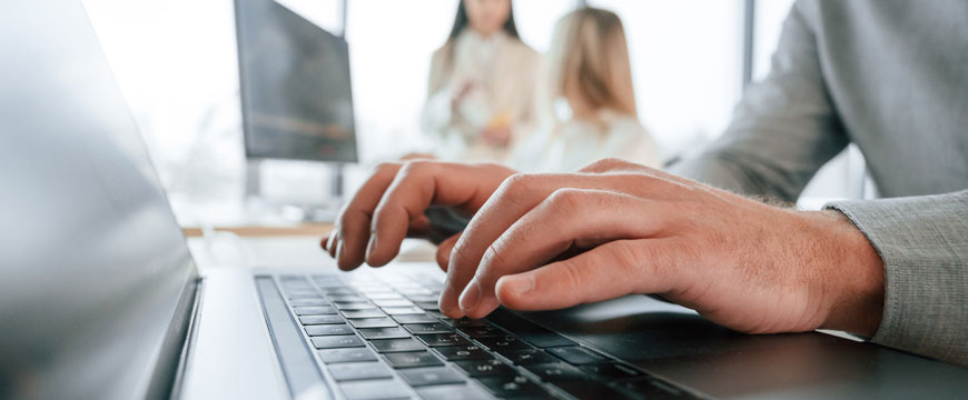 Persons Hands Working on a Computer