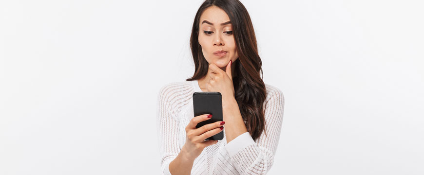 Gir looking at phone in confusion