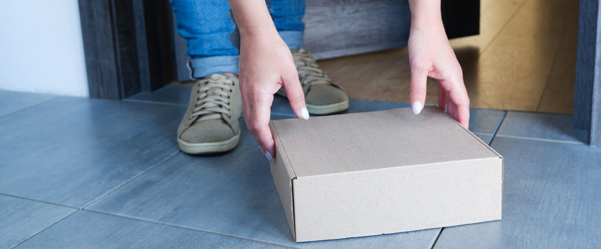 Person grabbing a package off the porch