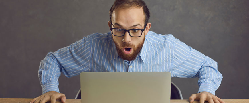 Person Looking at Computer in Shock