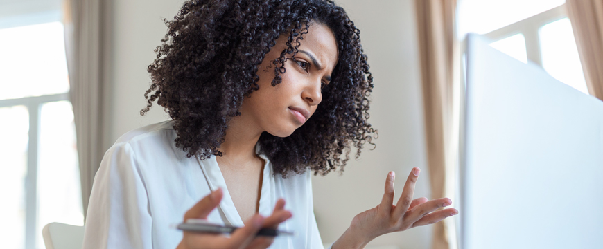 Girl looking at a computer screen in confusion