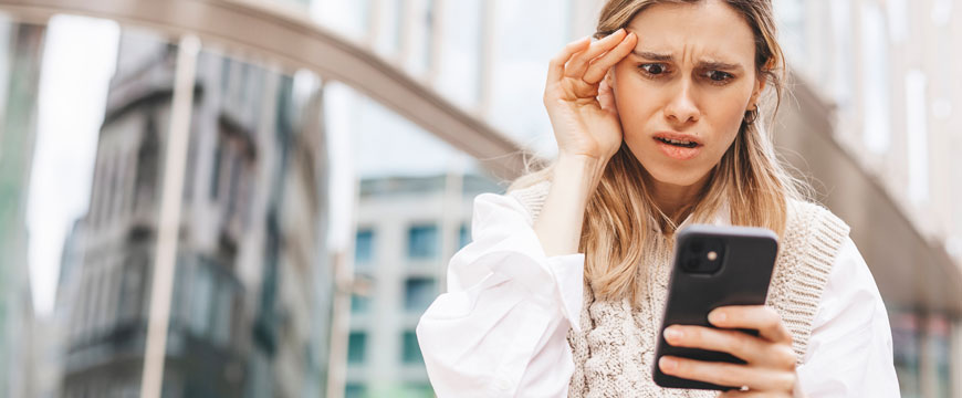 Girl Looking at a Phone in Confusion