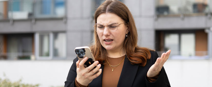 Girl Looking at a Phone in Confusion