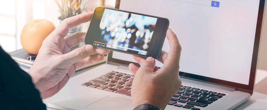 Person Holding a Phone and Watching a Video