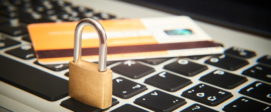 Lock with a debit card on top of laptop keyboard