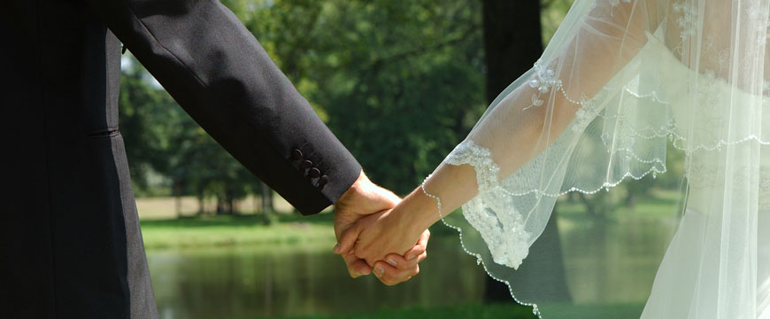 Getting Married, Bride and Groom holding hands outside