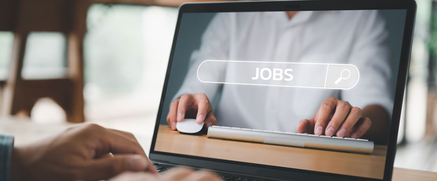 Hands Typing on a Computer Under "Job Search"