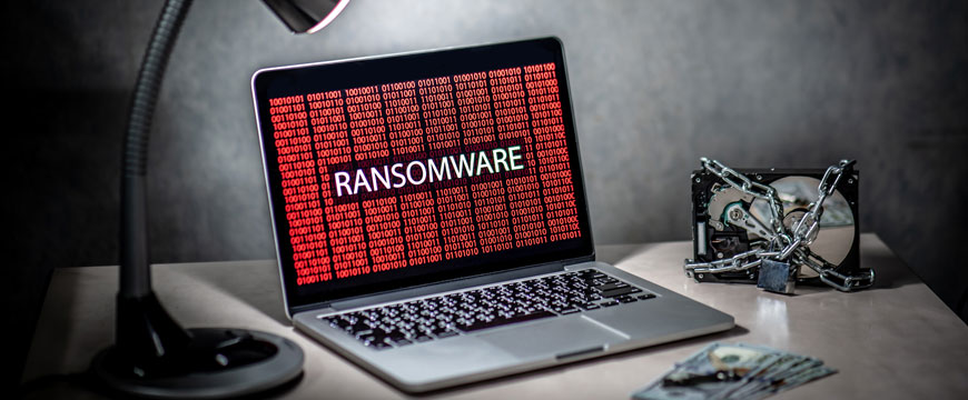 Laptop on Desk with Ransomware Alert on Screen