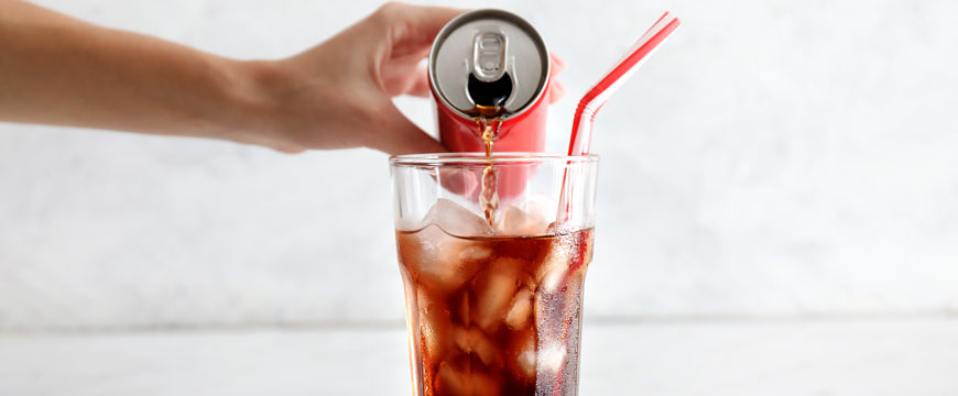 Hand Pouring Soda into a Glass