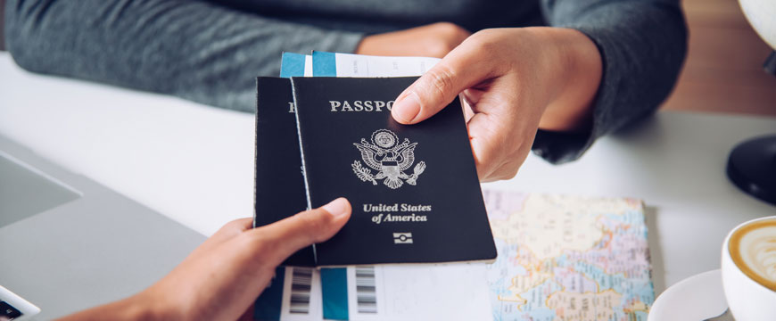 Hands Holding Passports at Airport
