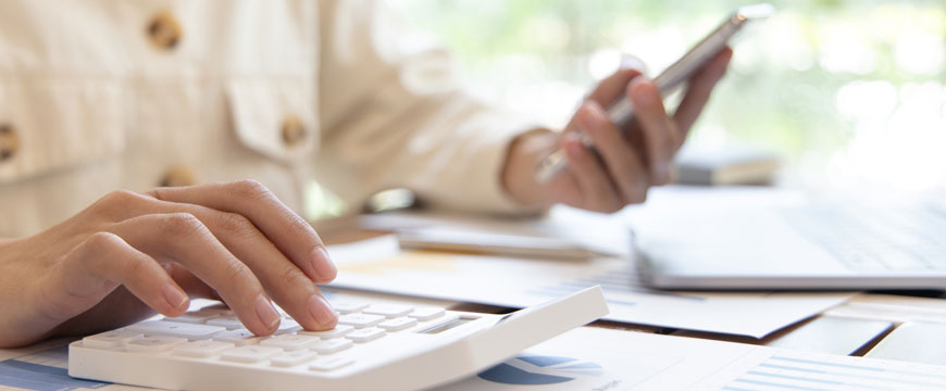 Person Doing Taxes with Calculator