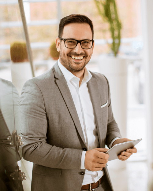 Businessman in suit holding tablet