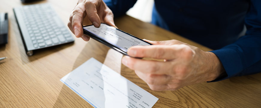 Gentleman using phone to make a mobile deposit