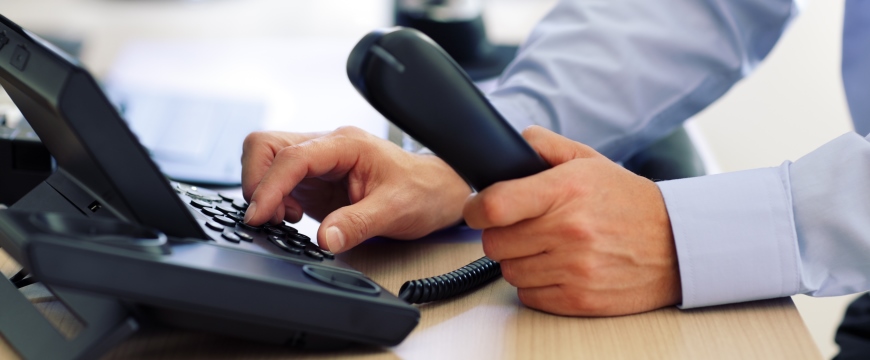 Telephone Banking, image of a man's hands entering numbers on a touch tone phone