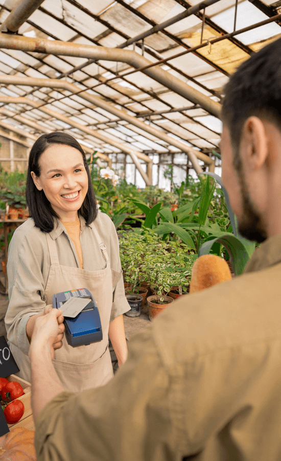 Man making purchase in green house