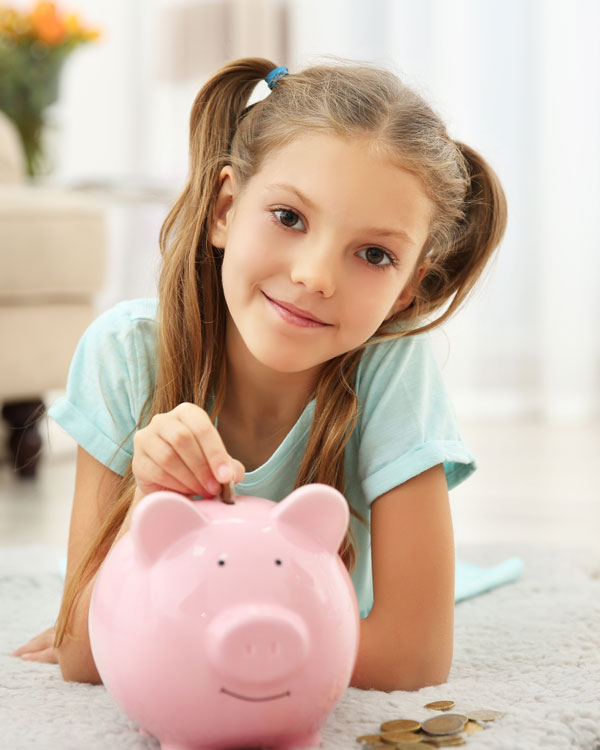 Little girl with piggy bank