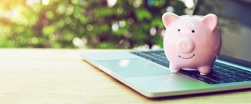 Savings and Money Market, piggy bank sitting on laptop