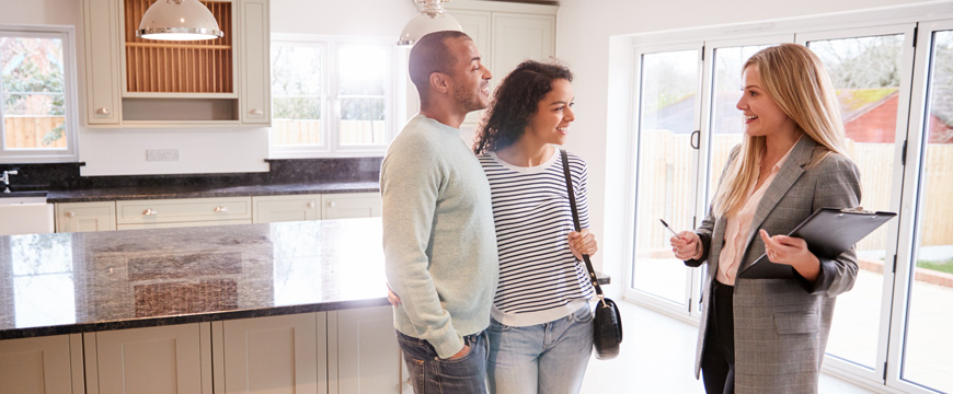 couple touring a house with a realtor