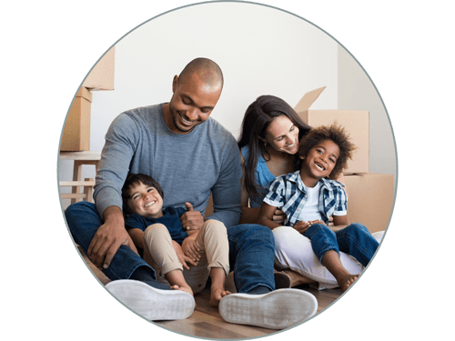 Couple with children and boxes in new home