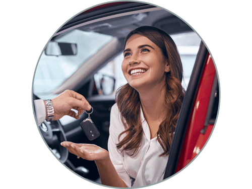 Woman receiving keys to new car