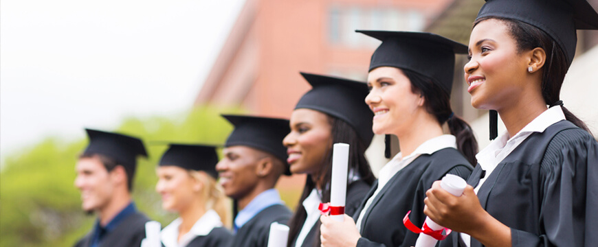 Starting College, A row of smiling graduates in cap and gown holding diplomas